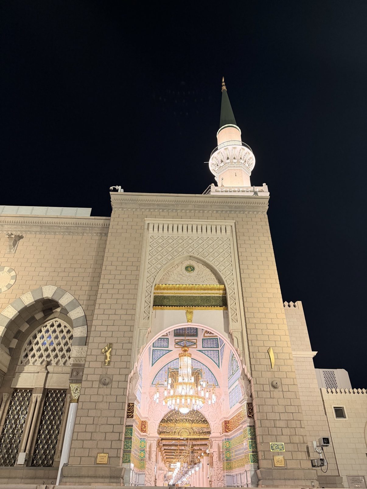 A white mosque glowing against the night