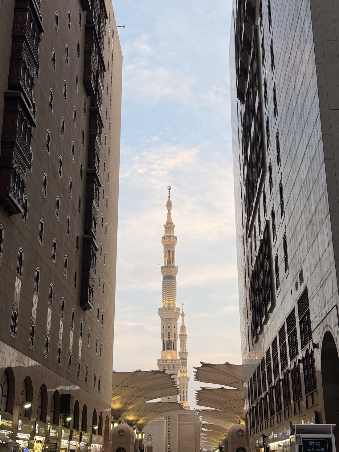 A minaret of the Prophet's Mosque seen between the hotels on the walk from the Haram at dawn