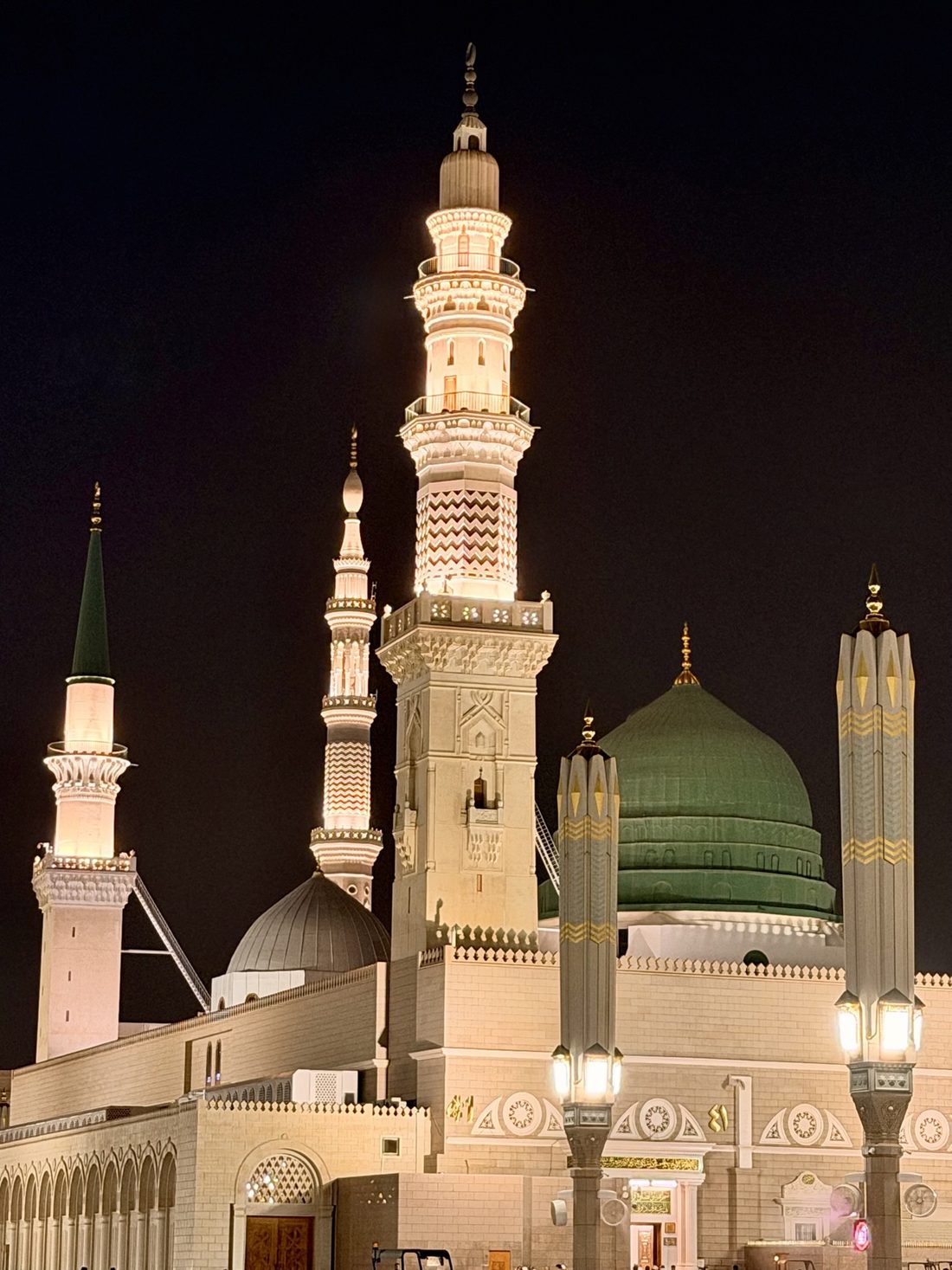 The Green Dome and illuminated minarets of the Prophet's Mosque at night